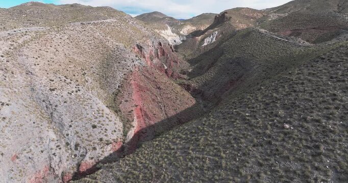 Aerial view of colorful sediment canyon with layered geology Tabernas Desert Spain dramatic terrain