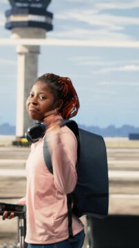 Vertical Video Foreign student, waving goodbye to tearful parents, emotional moment in airport, solo traveler leaving sad but proud mother and father to study abroad. International flight departure.