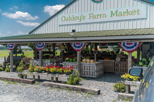 Local farm market in Virginia with wooden crates of produce and Oakleys Farm Market sign