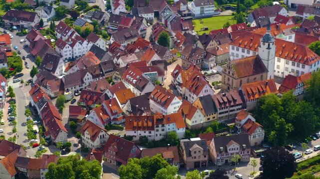 An panoramic aerial view around the old town in the city Waldenbuch on a sunny summer noon in Germany .