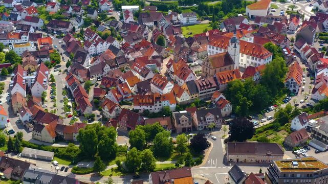 An panoramic aerial view around the old town in the city Waldenbuch on a sunny summer noon in Germany .