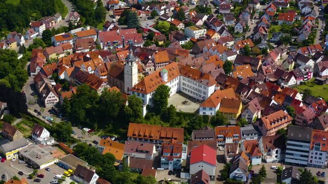 An panoramic aerial view around the old town in the city Waldenbuch on a sunny summer noon in Germany .