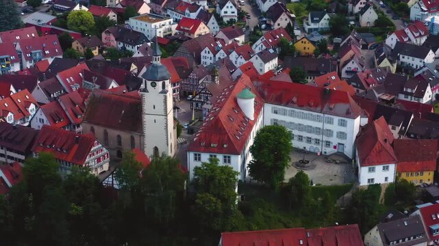An panoramic aerial view around the old town in the city Waldenbuch on a sunny summer noon in Germany .