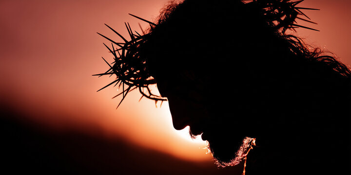 silhouette of jesus christ suffering at the cross and wearing the crown of thorns