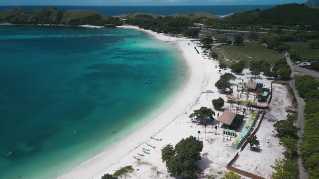 Aerial View Resort Coastline With White Sand, Sun Loungers, Beachfront Facilities, Turquoise Water And Scattered Boats, Tanjung Aan,Kuta,Lombok,Indonesia