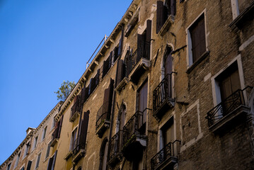 Fototapeta premium Venetian architecture with balconies against clear blue sky