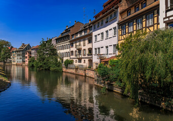Fototapeta premium Half timbered houses with flowers, canals of Petite France in Strasbourg, France