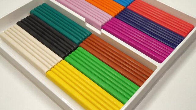 Colorful pieces of plasticine in a box. Soft modeling clay blocks for creative fun. Colorful blocks of modeling clay for art projects. Fun clay blocks for skillful modeling