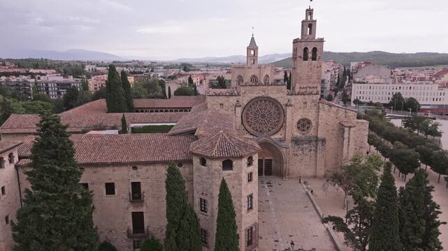 Drone descending towards sant cugat del valles monastery in spain
