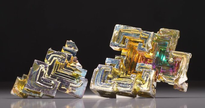 Bismuth crystals. Bismuth - chemical element with symbol Bi and atomic number 83. Post-transition metal and one of pnictogens. Synthesized bismuth crystal. Iridescent coloration is due to oxide film