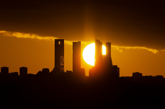Sunset behind the four towers of the Castellana in Madrid