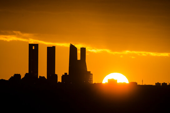 Sunset behind the four towers of the Castellana in Madrid