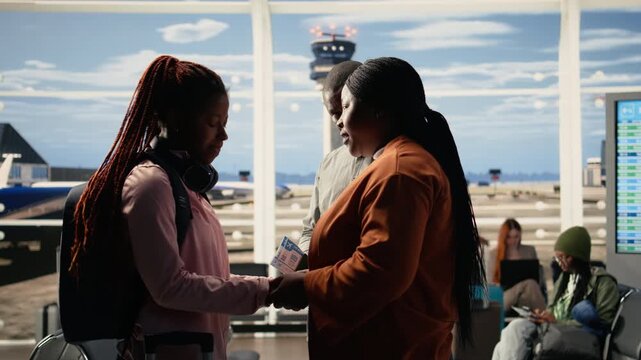 Supportive parents and teenage child in sad goodbye at the airport terminal, the pain and pride of sending young solo traveler to study abroad. International student life, departure time.