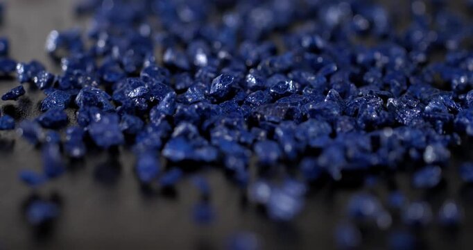Super slow motion, Tiny Gemstones Cascade Peacefully. Delicate Lapis Fragments Scatter Softly Across Smooth