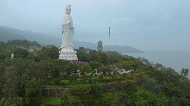 Aerial view of the Lady Buddha statue at the Linh Ung Pagoda in Da Nang, Vietnam. Tourists visit the temple to worship and enjoy the views of the city and coastline.