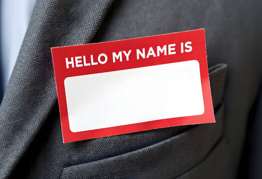 Red hello my name is sticker on suit jacket