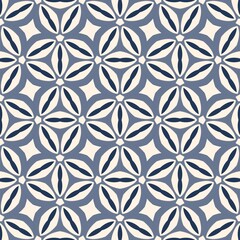 Fototapeta premium A blue and white patterned design with a flower in the center. The design is made up of circles and triangles