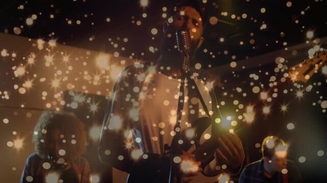 Camera pushing in sparkles covering faces, lead singer playing guitar and singing, showing music