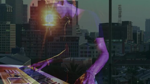 Male keyboardist pressing keys and initiating layered reveal over skyline, creating ambient music