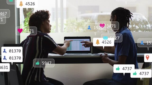 Right person pointing at laptop starting badges growing while pair discussing feedback