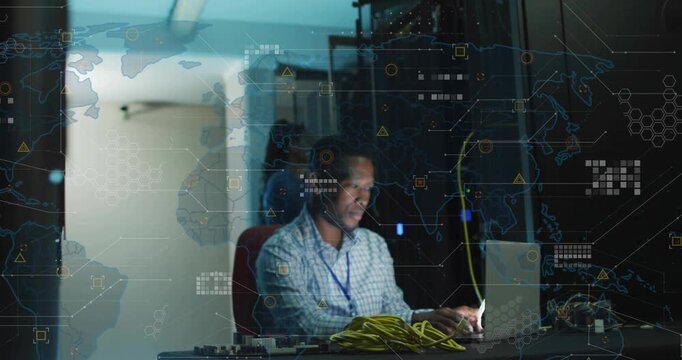 IT technician typing laptop in server room, initiating animated network map overlays for monitoring