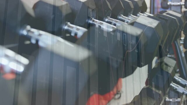 Cam panning right across gym rack, revealing red towel while charts over rack showing fitness stats