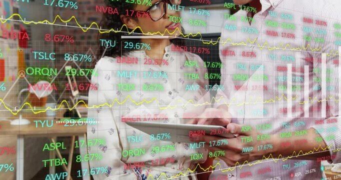 Woman holding tablet, man approaching taking it, reviewing finance overlay with tickers and charts