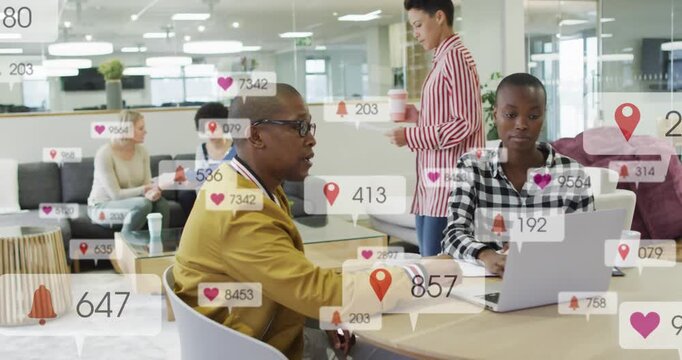 Man pointing while woman typing at laptop, causing hearts, pins, counters floating for marketing