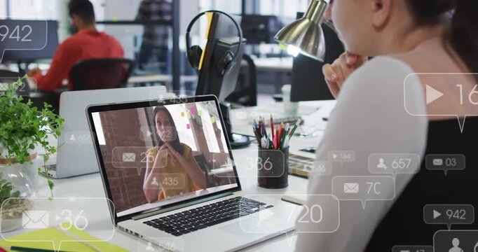 Marketing woman watching laptop as speaker streaming animating play icons and fan counts rising