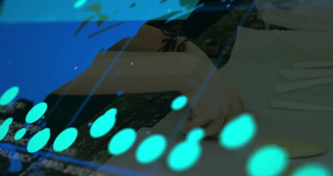 Woman's hands responding to sweeping data overlay, picking up object to verify numeric analytics