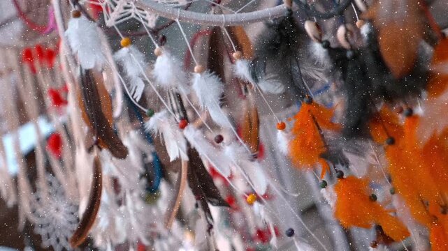 Indian traditional colorful, gentle Dream Catchers fluttering in the wind attracting tourists to buy in the city of Pushkar, India. View through sparkling particles. Slow mo, slo mo, slow motion