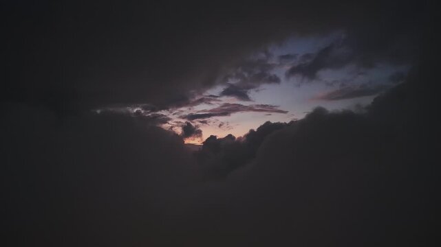 Moon hidden by clouds being revealed again by moonlight