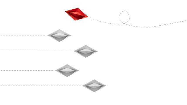 group of blue paper boats are sailing in one direction, one red is sailing in the opposite direction. The concept of an extraordinary personality