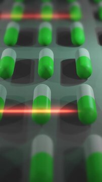 Green and White Drug Pills or Capsules being Produced in Lab - Vertical