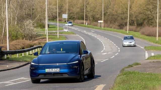 Milton Keynes,Bucks,UK - Mar 15th 2026: 2025 blue Tesla Model Y electric car driving on a British road