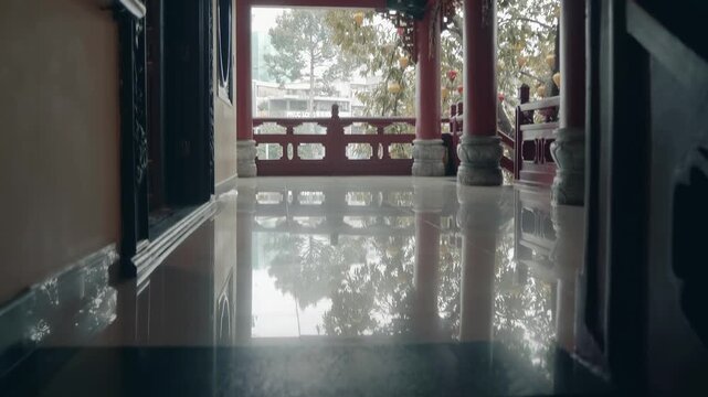 A spacious balcony of Chua Phap Hoa Buddhist temple with marble floor, stone columns, traditional Asian style bended roofs and dharma chakra symbol . Ho Chi Minh City, Vietnam