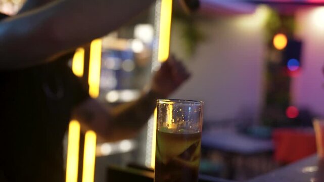 Close up of bartender muddling ingredients for a fresh cocktail