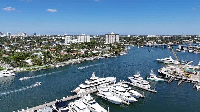 Aerial view of boats cruising in the intracoastal waterway with large yachts docked at port in Fort Lauderdale in Broward County, Florida.