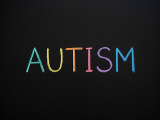 Obraz premium autism written in neat colored chalk lettering on clean blackboard minimal education concept