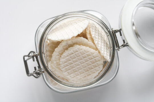 Top view of a jar of thin, crispy traditional wafers known as simping in Indonesia.