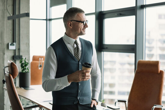 Coffee break. Businessman in corporate office. Business man at coffee break. Businessman relaxing with coffee cup. CEO having free time. Business break for drinking. Businessman drinking coffee