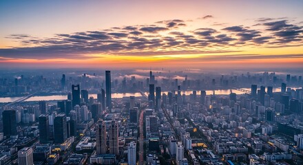 Fototapeta premium Breathtaking panoramic view of a modern urban skyline at sunrise, showcasing countless towering skyscrapers, a winding river, and a vibrant sky painted with warm hues of dawn