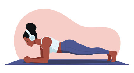 Fototapeta premium Fit young woman with headphones performing a forearm plank on a yoga mat during a workout session at home or gym.