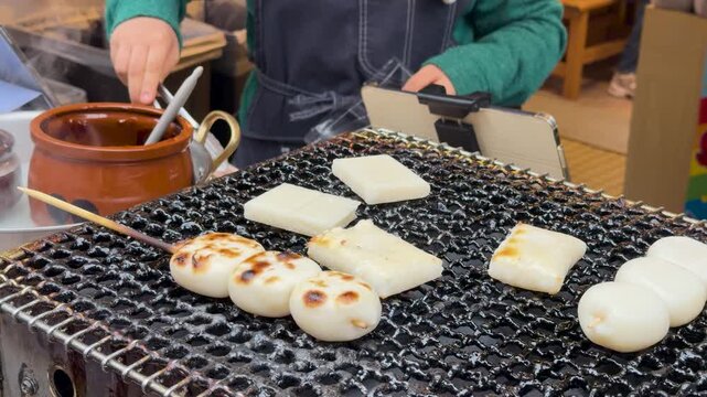 Japanese Street Food Vendor Grilling Mochi and Dango on Charcoal Grill