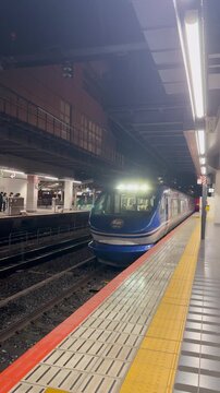 Blue Express Train Arriving at Kyoto Station Platform at Night