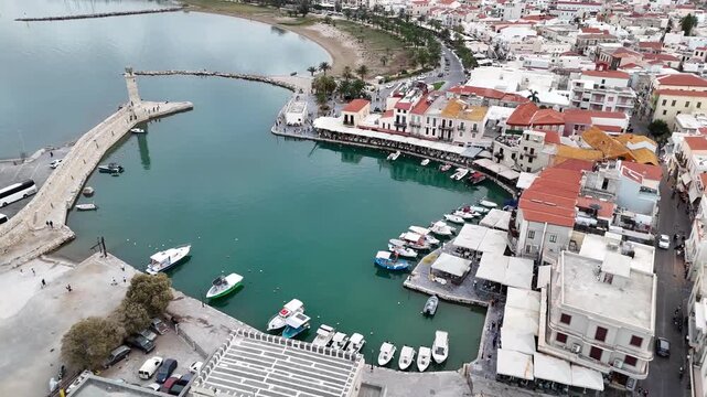 Aerial revealing shot of the old town of rethymno with its venetian harbour and egyptian lighthouse