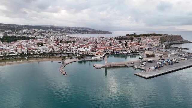 Stunning panoramic aerial view of the coastal city of rethymno and its old harbor on a cloudy day