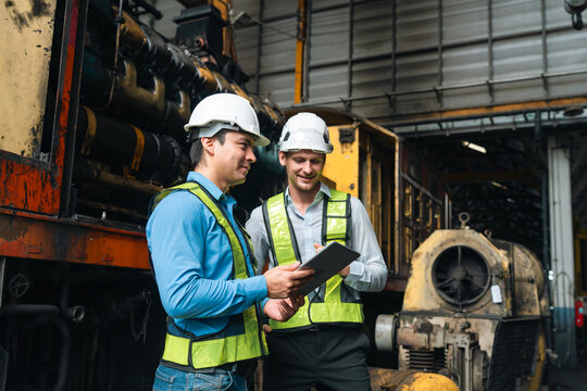 professional technician engineer with safety helmet hard hat working in industrial manufacturing factory, men at work to checking equipment of machinery production technology or construction operating