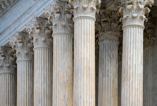 Columns stone architectural perspective layout. Columns marble symmetry repetition. Columns decorative capitals carved detail. Columns facade.