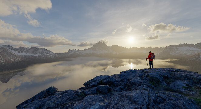 Hiker Overlooking Misty Mountain Lake At Sunrise With Backpack And Trekking Poles &mdash; 3D Rendering